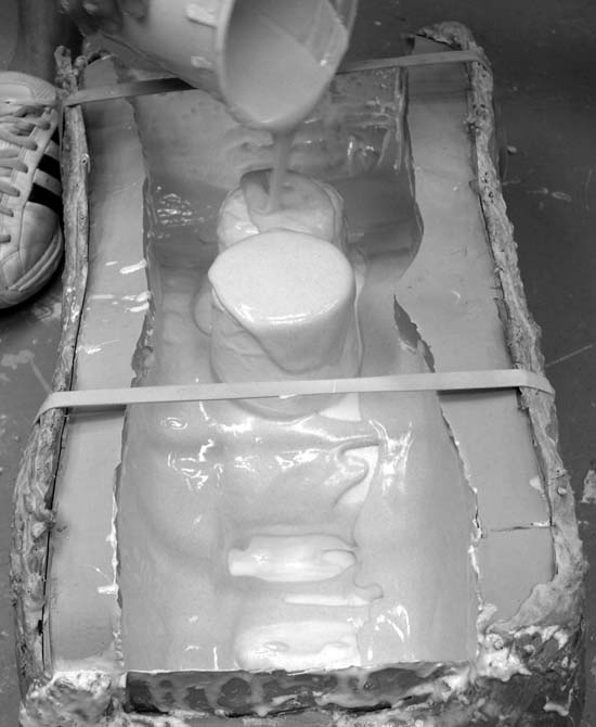 A layer of thickened plastic being added to the mold