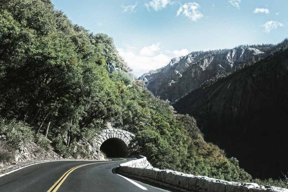 Photograph of a mountain road leading to a tunnel. 