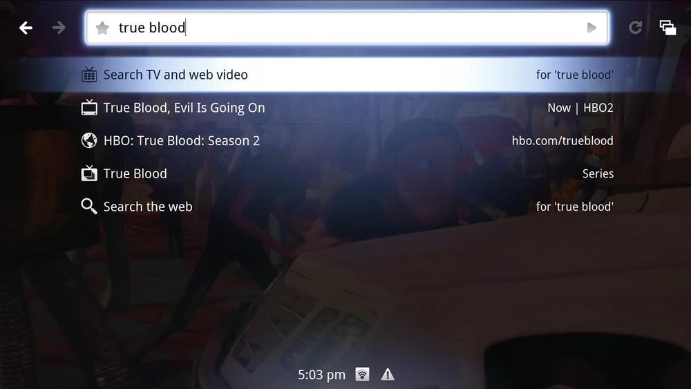 The Quick Search Box (QSB) on Google TV combines results from TV programs, videos, and web pages